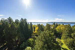 Extensive view over green forests to a distant lake under a clear sky