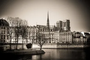 The exterior of Notre Dame Cathedral is prominently displayed along the Seine River in Paris
