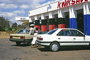 Exterior view of a Mobil petrol station and a Kwiksave PTC shop, Malawi, southern Africa, 1989, Africa