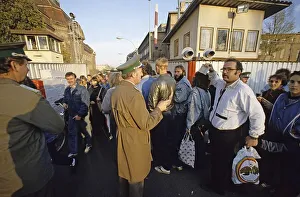 Fall of the Berlin Wall: citizens from East Berlin return with shopping bags at the border crossing Invalidenstrasse