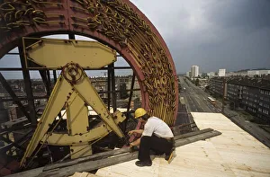 Fall of the Berlin Wall, construction workers removing a GDR symbol in East Berlin