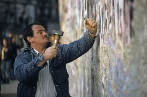 Fall of the Berlin Wall: man chiselling pieces off the Wall (Mauerspecht)
