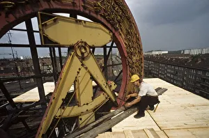 Fall of the Berlin wall, worker dismantling a GDR symbol in East Berlin