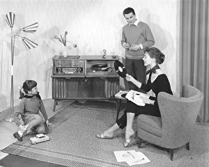 Family in the living room in front of the stereo