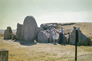 Family in front of long barrow burial chamber, West Kennet-Wiltshire, England, UK 1976