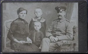 Family, man in uniform, woman and two boys