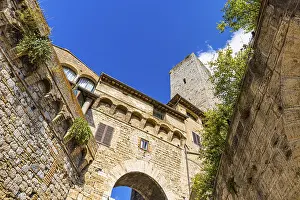Family tower and medieval buildings against a blue sky