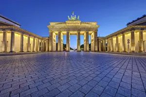 The famous illuminated Brandenburg Gate in Berlin at dusk