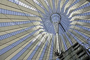A fanned out tent roof made of fabric and fastened with tie rods to a steel ring
