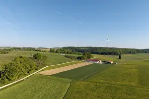 Farm, green fields stretch out under a blue sky