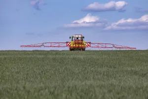 Farmer with tractor. In spring