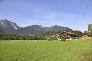 Farmhouse with mountain backdrop