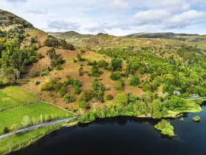 Framed Print : Farms and Mountains over road A591 from a drone