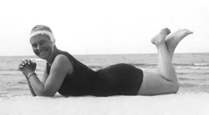 Fashion, swimwear, woman lying on the beach with swimsuit and bathing cap
