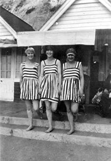Fashion, swimwear, three women in the same striped swimsuits
