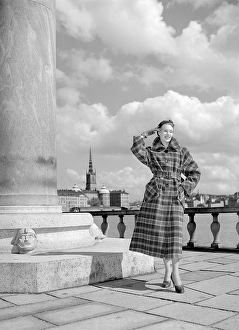 Fashionable in the 1950s. A young woman wears a typical 1950s coat