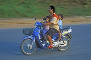 Father with his two children on a moped
