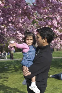 Father and daughter enjoying bloom of cherry trees at Botanical Garden