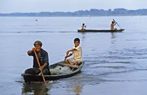 Father and son in a paddle boat on the Amazon near Iquitos