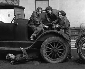 Female car mechanics fixing a car