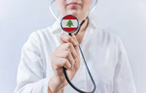 Female doctor holding stethoscope with Lebanon flag