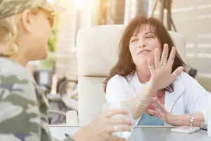 Two female friends enjoying conversation on the patio