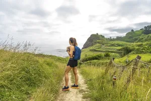 Female hiker enjoying the scenic view of sakoneta beach and its flysch cliffs in zumaia