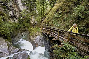 Female hiker standing on wooden walkway