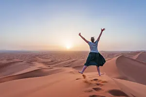 Female hiker is stretching arms in the air