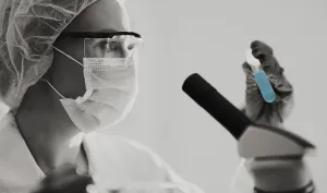 Female scientist working with test tubes in lab