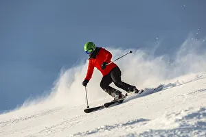 Female skier descending steep slope