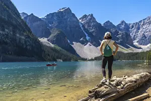 Female tourist standing on a log