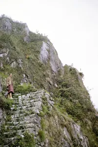 Female tourist on the steep mountain path Huayna Picchu, Machu Picchu, Peru, South America around 1962, South America