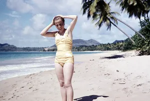 Female tourist in swimming costume on the sandy beach of Vigie, St Lucia, Windward Islands, West Indies, 1962