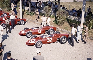 Ferrari Formula One Team in the paddock with shark nose Ferrari 156 F1 cars, Ferraris, Monza Grand Prix, Italy 1961 thought to be Baghetti talking to a mechanic on the right