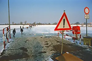 Ferry dock, people walk across ice rink