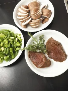Filet steak of red deer with ingredients in a kitchen