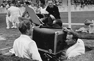The film operator shoots the big Olympic film in the pit with the giant camera