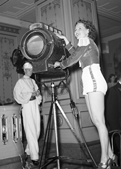 Film studio in the 1940s. A young woman pictured in a film studio beside a spotlight