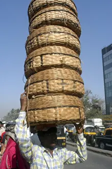 Fish seller carrying six baskets on head