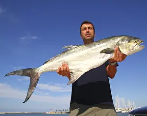 Fisherman holding catch Garrick Lichia Amia Leerfish Leervis fishJack