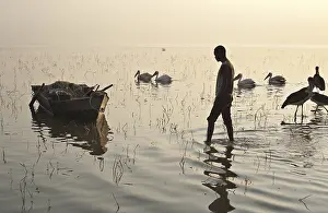 Fisherman walking to his boat before going to fish