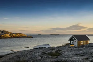 Fisherman's cottage by the sea at sunset