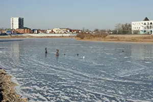 Fishermen catch fish on the river, winter fishing