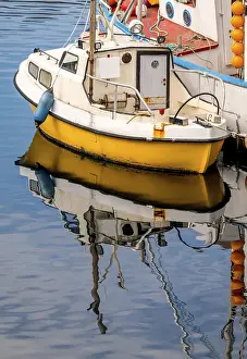 Fishing boat with reflection in the harbour of Honningsvag