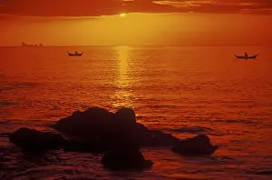 Fishing boats at sunset, silhouettes