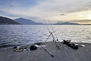 Framed Print : Two fishing rods on a tripod with many accessories set up on Lake Zug