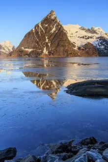 Fjord with ice floes in front of steep mountains