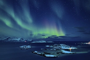 Fjord with islands in winter and the northern lights