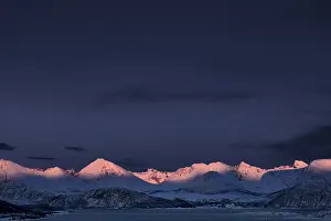 Fjord with mountain peaks during the blue hour